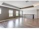 A loft with multiple windows, modern flooring and a pendant light at 7628 Surf Reed Way, Wesley Chapel, FL 33545