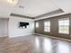 Upstairs loft area featuring stylish flooring, modern television and plenty of natural light at 7628 Surf Reed Way, Wesley Chapel, FL 33545