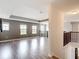 Upstairs loft area with plenty of natural light, complemented by stylish flooring and modern fixtures at 7628 Surf Reed Way, Wesley Chapel, FL 33545