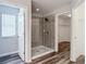 Bathroom featuring a large glass enclosed shower and access to the walk-in closet at 7628 Surf Reed Way, Wesley Chapel, FL 33545