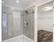 Large glass-enclosed shower with tiled walls and shower head at 7628 Surf Reed Way, Wesley Chapel, FL 33545