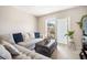 Inviting living room with plush sectional sofa and sliding door to balcony at 801 Russell Ln # 252, Brandon, FL 33510