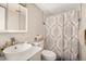 Bathroom featuring contemporary vanity with a decorative mirror, patterned shower curtain, and neutral color palette at 801 Russell Ln # 252, Brandon, FL 33510