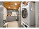 Compact kitchen with wood plank ceiling, stainless steel appliances, and laundry at 801 Russell Ln # 252, Brandon, FL 33510