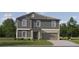 Charming two-story home featuring a well-manicured lawn, gray siding, and an attached two-car garage at 8064 Painted Sky Pl, Land O Lakes, FL 34637