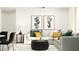 Cozy living room with a white sectional sofa, round ottoman coffee table, and stylish abstract art at 8064 Painted Sky Pl, Land O Lakes, FL 34637