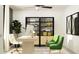 Home office with green chairs, sleek desk, modern decor, and ample natural light from window at 8064 Painted Sky Pl, Land O Lakes, FL 34637