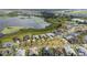 Aerial view of homes backing onto a lake with lush landscaping in a residential community at 8834 Sanders Tree Loop, Wesley Chapel, FL 33545