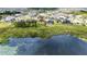 Backyard with an in-ground pool backing onto a lake in a residential community at 8834 Sanders Tree Loop, Wesley Chapel, FL 33545