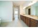 Bathroom with double vanity, ample storage and views to the shower, bathtub and bedroom at 8834 Sanders Tree Loop, Wesley Chapel, FL 33545
