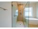 Bright bathroom featuring a glass shower and soaking tub at 8834 Sanders Tree Loop, Wesley Chapel, FL 33545