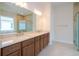Bathroom featuring a double vanity, a shower with glass door and a soaking tub at 8834 Sanders Tree Loop, Wesley Chapel, FL 33545