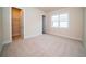 Bright bedroom featuring plush carpet, neutral walls, and a walk-in closet at 8834 Sanders Tree Loop, Wesley Chapel, FL 33545