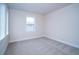 Empty room featuring bright, natural light, neutral carpet, baseboards, and a large window at 8834 Sanders Tree Loop, Wesley Chapel, FL 33545