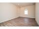 The empty bedroom features laminate flooring and a sunny arched window at 8834 Sanders Tree Loop, Wesley Chapel, FL 33545