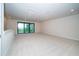 Large bonus room with ample natural light, and views of the lake, perfect for any use at 8834 Sanders Tree Loop, Wesley Chapel, FL 33545