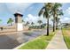 Gated entrance to King Lake Estates with stone pillar, palm trees and manicured landscaping at 8834 Sanders Tree Loop, Wesley Chapel, FL 33545