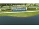Aerial view of Epperson community entrance with fountain and lush green landscaping and lake in foreground at 8834 Sanders Tree Loop, Wesley Chapel, FL 33545