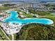 Aerial view of Epperson Lagoon community featuring white sand beach, turquoise water, and amenities at 8834 Sanders Tree Loop, Wesley Chapel, FL 33545