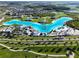 Aerial view of the Epperson Lagoon community, featuring beach, turquoise water, amenities, and houses at 8834 Sanders Tree Loop, Wesley Chapel, FL 33545