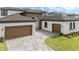 Spacious three car garage with paver driveway, ideal for car enthusiasts or extra storage space at 8834 Sanders Tree Loop, Wesley Chapel, FL 33545