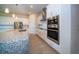 Close up of modern kitchen with stainless steel appliances, range hood and granite countertops at 8834 Sanders Tree Loop, Wesley Chapel, FL 33545