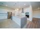 Bright kitchen equipped with stainless steel appliances, a granite island, and ample storage at 8834 Sanders Tree Loop, Wesley Chapel, FL 33545