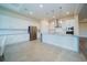 Bright kitchen with white cabinets, granite countertops, stainless steel appliances and pendant lighting at 8834 Sanders Tree Loop, Wesley Chapel, FL 33545