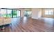 Open-concept living space with hardwood floors, large sliding doors, and great natural light at 8834 Sanders Tree Loop, Wesley Chapel, FL 33545