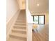 Staircase leading to the downstairs area of the house with a view of the backyard at 8834 Sanders Tree Loop, Wesley Chapel, FL 33545