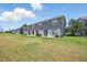 Townhome backyard with green grass and gray exterior at 8856 Christie Dr # 0, Largo, FL 33771