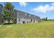 Backyard showing chairs and a grill with grassy area at 8856 Christie Dr # 0, Largo, FL 33771