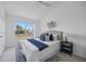 Comfortable bedroom with a large window offering scenic views, plush bedding and stylish decor at 8856 Christie Dr # 0, Largo, FL 33771