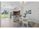 Bright dining area with white table, chairs, and sliding glass door to the backyard, perfect for enjoying meals at 8856 Christie Dr # 0, Largo, FL 33771