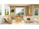 Cozy living room featuring a sofa, accent chair, modern decor, and a view to the dining room and patio at 9332 Cannon Beach Dr, Parrish, FL 34219