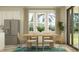 Bright dining area with a wooden table, stylish chairs, and large windows offering a scenic outdoor view at 9456 Gladsome Dr, Land O Lakes, FL 34637
