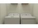 A well-lit laundry room featuring a white washer and dryer at 9456 Gladsome Dr, Land O Lakes, FL 34637