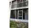 Enclosed ground floor balcony with stair access to the second story at 9722 Indian Key Trl # 116, Seminole, FL 33776