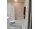 Clean and functional bathroom with a shower-tub combo, white fixtures, and a tiled floor at 9722 Indian Key Trl # 116, Seminole, FL 33776