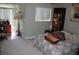 Cozy bedroom with ample natural light, a comfortable bed, and shelving with books for a relaxing ambiance at 9722 Indian Key Trl # 116, Seminole, FL 33776