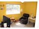 Comfortable bedroom with a large window, dark recliner, neutral carpet, and a ceiling fan at 9722 Indian Key Trl # 116, Seminole, FL 33776