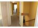 Hallway featuring plush carpet, a view of a bright living space, and convenient access to downstairs at 9722 Indian Key Trl # 116, Seminole, FL 33776