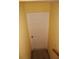 Hallway with a white door and yellow walls at 9722 Indian Key Trl # 116, Seminole, FL 33776