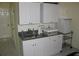 Efficient kitchenette featuring white cabinets, countertop, and stainless steel sink at 9722 Indian Key Trl # 116, Seminole, FL 33776