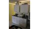 Practical kitchenette featuring white cabinets and a stainless steel sink at 9722 Indian Key Trl # 116, Seminole, FL 33776