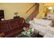 Comfortable living room featuring a staircase, sofas and a coffee table at 9722 Indian Key Trl # 116, Seminole, FL 33776