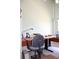 A well-lit office with a large desk, comfortable chair, and bright window with blinds at 9722 Indian Key Trl # 116, Seminole, FL 33776