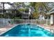 Inviting community pool with lounge chairs and a white fence surround at 9722 Indian Key Trl # 116, Seminole, FL 33776