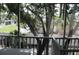 Enclosed porch with railing and tree-lined views at 9722 Indian Key Trl # 116, Seminole, FL 33776