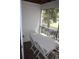 Porch with a dining set, screened windows and blinds at 9722 Indian Key Trl # 116, Seminole, FL 33776